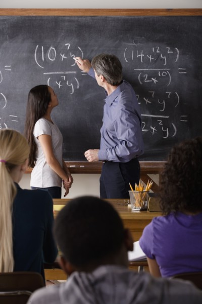 Teacher with teenage students (14-15,16-17) at school. 
Photo: Rob Lewine