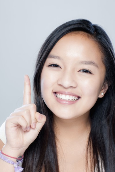 Portrait of teenage girl (14-15), studio shot. 
Photo: Rob Lewine