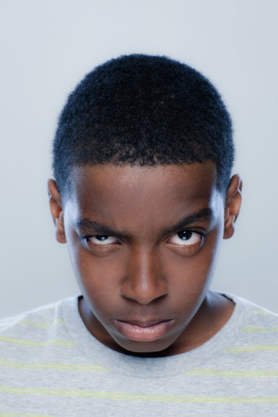 Portrait of teenage boy (14-15), studio shot. 
Photo : Rob Lewine