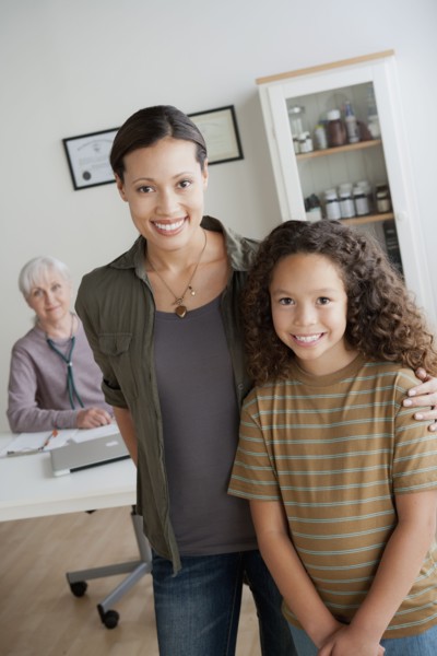 Girl (8-9) with mother at doctor's office. 
Photo : Rob Lewine