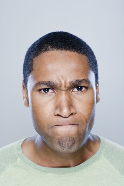 Portrait of young angry man, studio shot. 
Photo: Rob Lewine