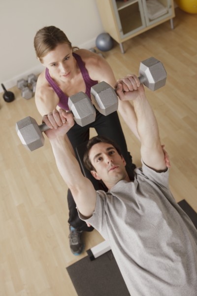 Young couple exercising with dumbbell. 
Photo : Rob Lewine