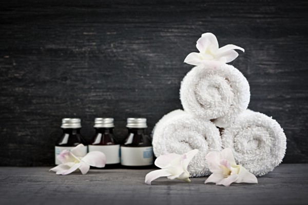 Still life with bottles, flowers and towels. 
Photo : Elena Elisseeva