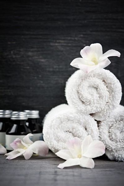 Still life with bottles, flowers and towels. 
Photo : Elena Elisseeva