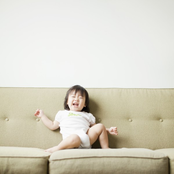 Baby girl (12-17 months) on sofa. 
Photo: Jessica Peterson