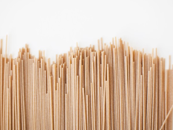 Spaghetti on white background, close-up. 
Photo: Jessica Peterson