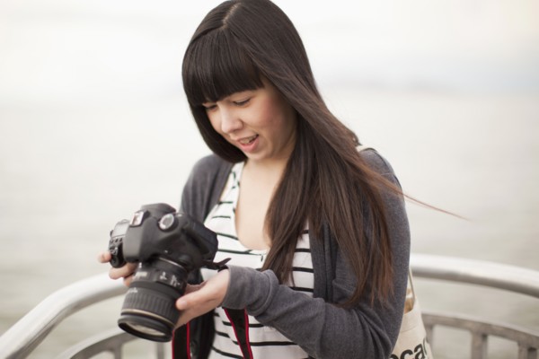 Young woman checking photos in camera. 
Photo: Jessica Peterson