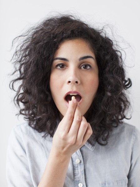 Young woman taking pill. 
Photo: Jessica Peterson