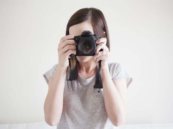 Young woman playing with digital camera. 
Photo: Jessica Peterson