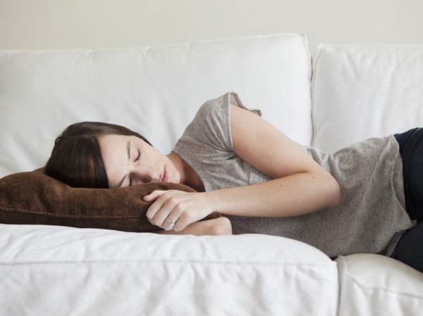 Young woman sleeping on sofa. 
Photo: Jessica Peterson