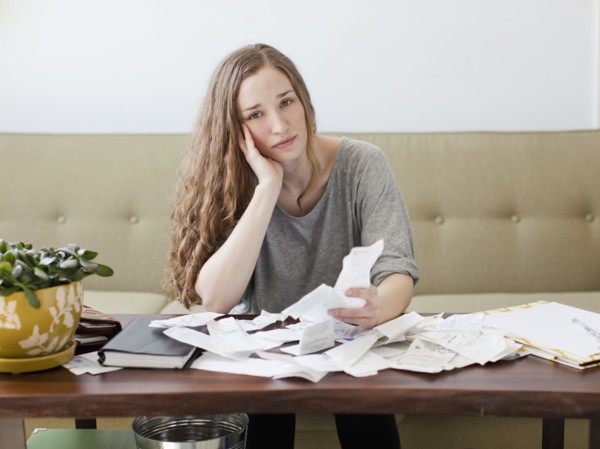 Young woman going though domestic paperwork. 
Photo: Jessica Peterson