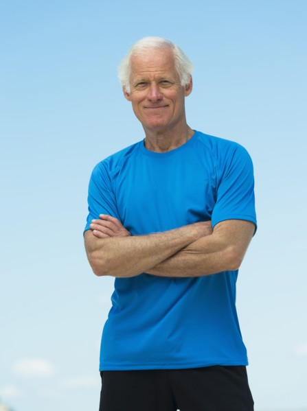 Portrait of senior man standing outdoors.