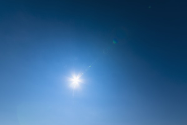Blue sky lit with bright sunshine.