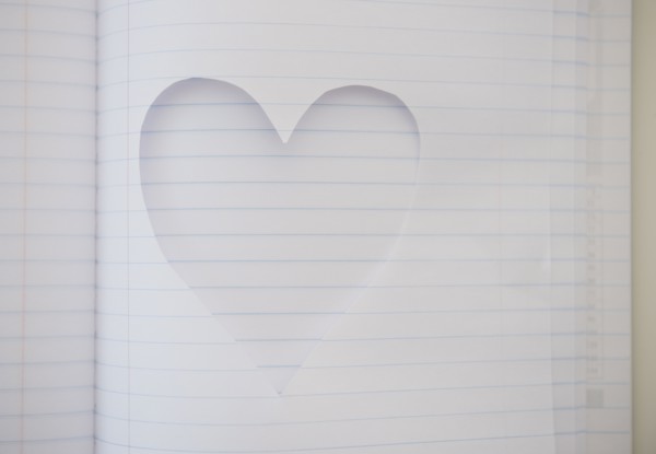 Heart shape cut out of note book. Photo : Jamie Grill
