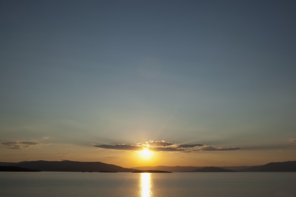 USA, Montana, Flathead Lake, View of sunset over lake. Photo: Noah Clayton