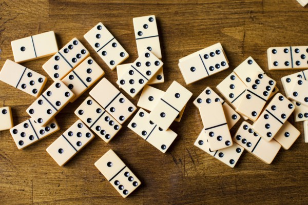 Domino tiles on wooden surface, studio shot. Photo : Jessica Peterson