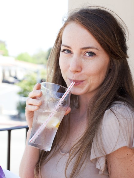 Portrait of young woman drinking water. Photo : Jessica Peterson
