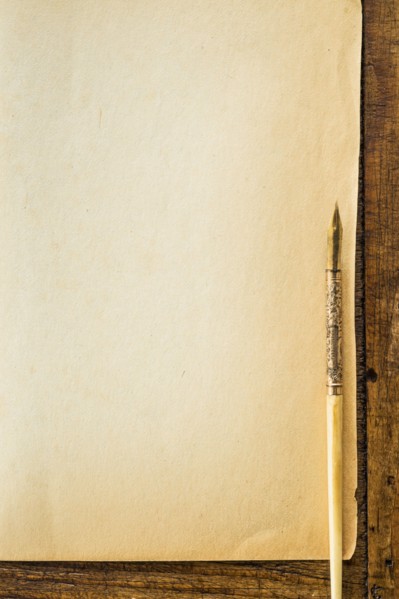 Old brown paper with fountain pen, studio shot.