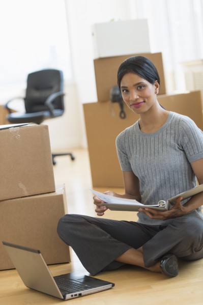 Businesswoman reading documents in new office.