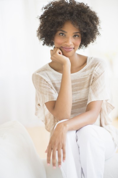 Portrait of woman sitting on sofa.