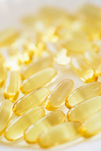 Omega fatty acid pills on white background, studio shot.