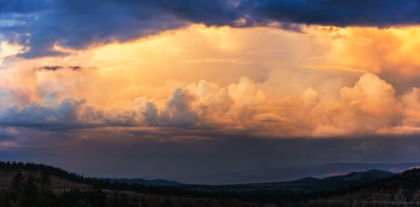 Clouds above valley at dusk.