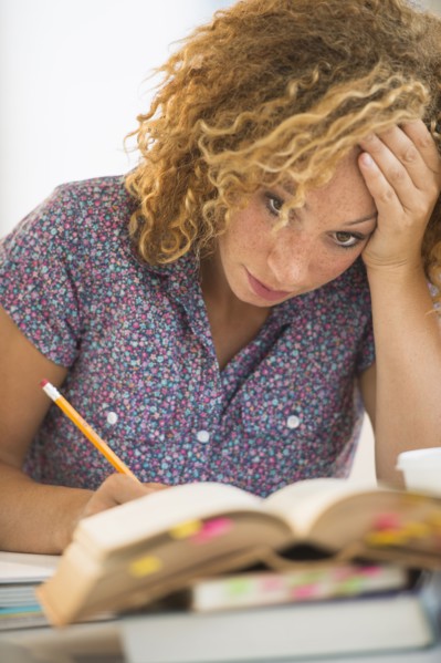 Young woman studying in library.