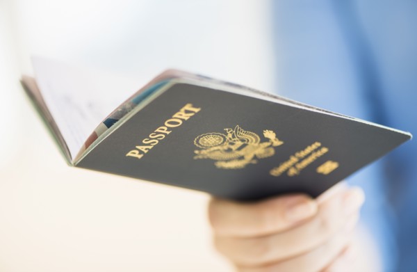 Close up of woman's hand holding open passport.