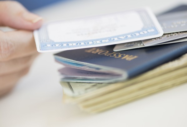 Close up of woman's hand holding Social Security Card.