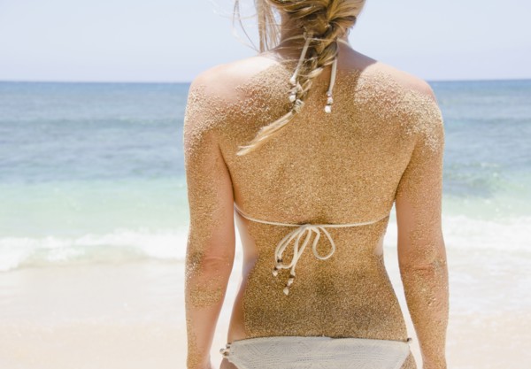 Woman's back with sticking sand . Photo: Jamie Grill