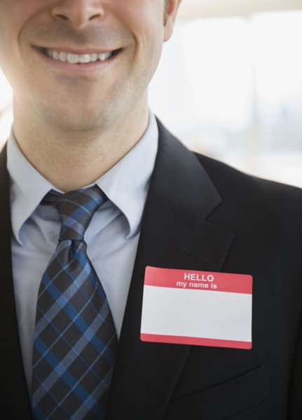 Office worker with name tag on suit. Photo : Jamie Grill