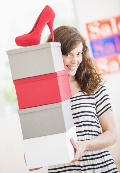 Woman carrying shoes boxes. Photo: Daniel Grill