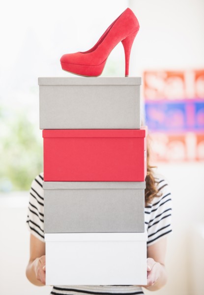 Woman carrying shoes boxes. Photo: Daniel Grill
