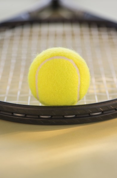 Studio Shot of tennis racket with ball. Photo : Daniel Grill