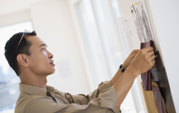 Mid adult fashion designer at work. Photo : Daniel Grill