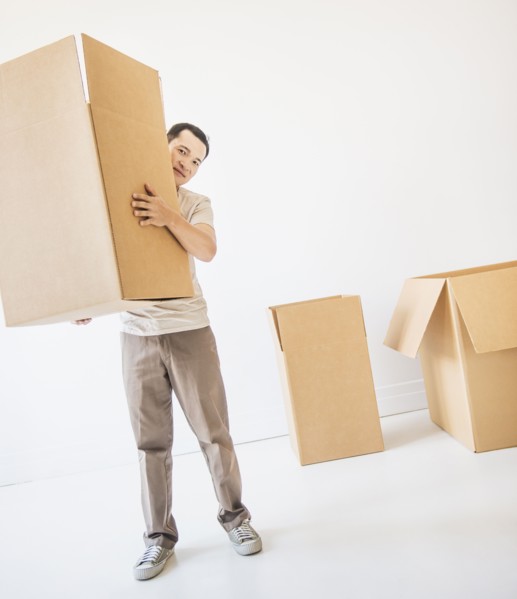 Mid adult moving cardboard boxes. Photo: Daniel Grill