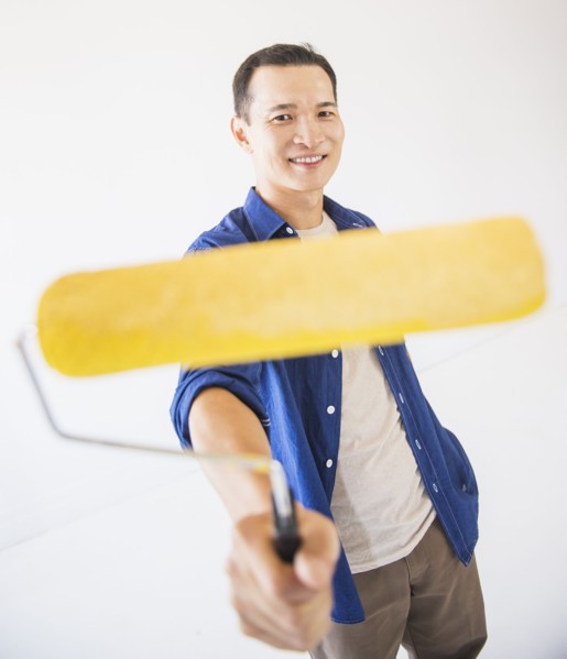 Man holding painting roll. Photo: Daniel Grill