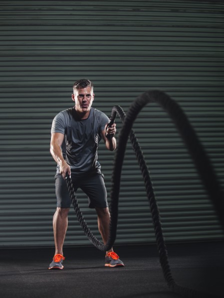 Mature man exercising with rope.