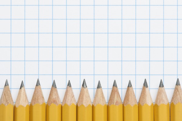 Row of sharpened pencils on graph paper, studio shot. Photo : Kristin Duvall