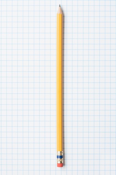 Single yellow sharpened pencil on graph paper. Photo : Kristin Duvall