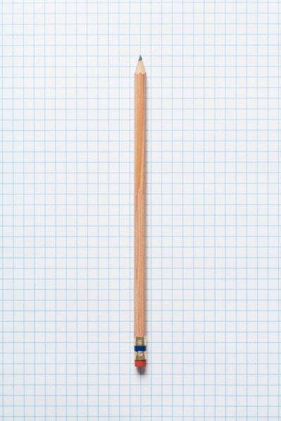 Single wooden sharpened pencil on graph paper. Photo : Kristin Duvall