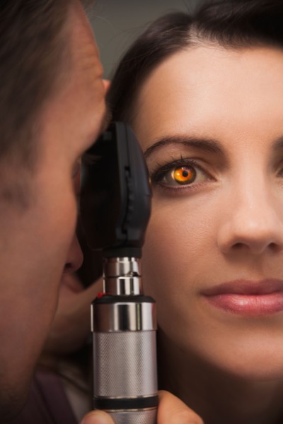 Close up of woman's eye lit up from doctor doing eye test. Photo : Mike Kemp
