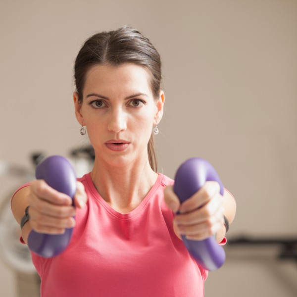 Young woman exercising with elastics. Photo: Mike Kemp