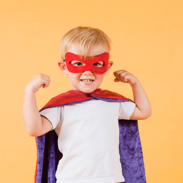 Studio shot, Portrait of smiling boy (2-5 years) showing his strenght. Photo: Jessica Peterson