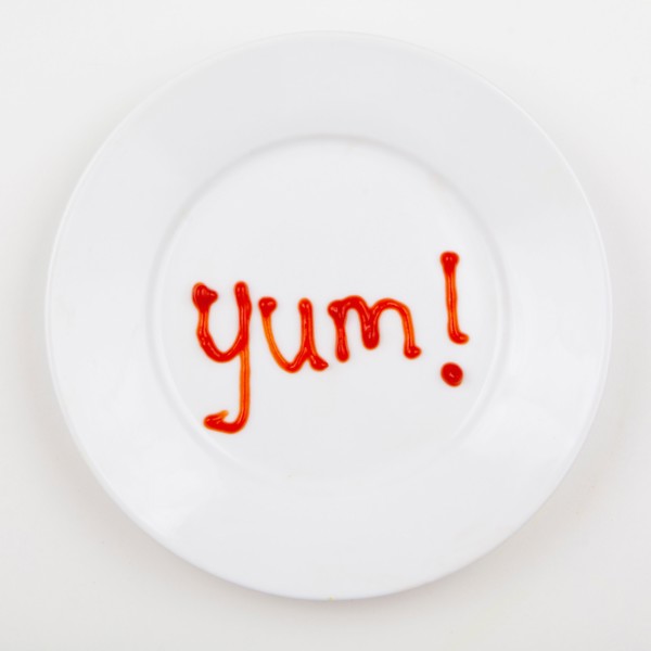 Word YUM written with ketchup. Photo : Jessica Peterson