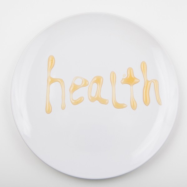 Word HEALTH on white plate. Photo : Jessica Peterson