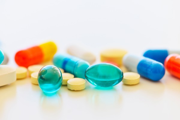 Colorful pills on white background.