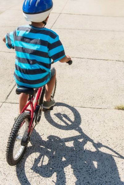 Boy (6-7) riding bicycle.