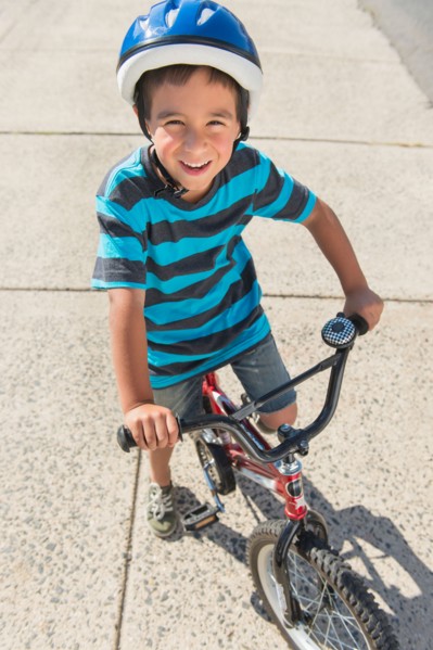Portrait of boy (6-7) riding bicycle.