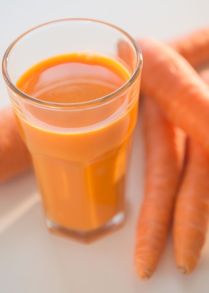 Studio shot of carrots and carrot juice
